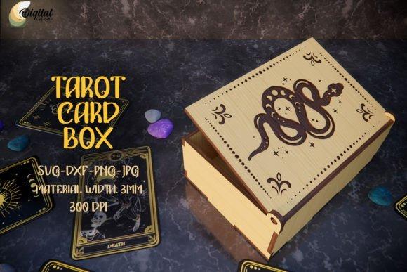 Laser Cut Box for Tarot Cards Laser cut box with engraved snake and celestial designs, surrounded by tarot cards and crystals