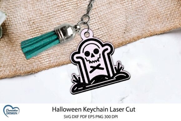 Halloween Laser Cut Keychain Halloween laser cut keychain with engraved skull and crossbones on tombstone design attached to teal tassel