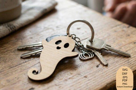Halloween Laser Cut Keychain Halloween laser cut keychain featuring a friendly ghost design with expressive eyes and a curled tail on a wooden surface
