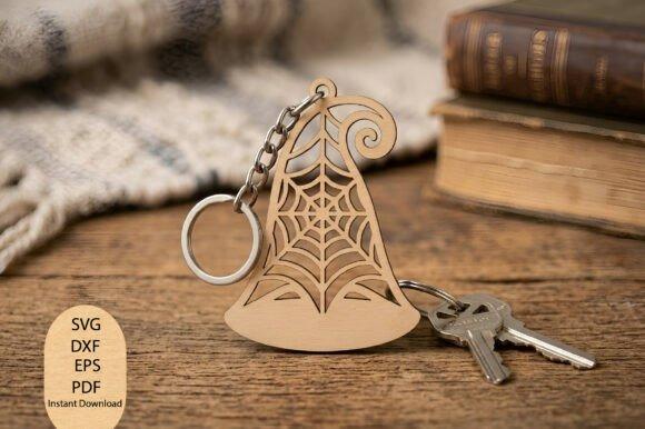 Halloween Laser Cut Keychain Halloween laser cut keychain shaped like a witch hat with spider web cutout details on a wooden surface