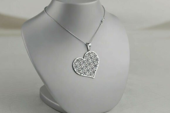 Heart shape pattern laser cut necklace with geometric and mandala design on display bust
