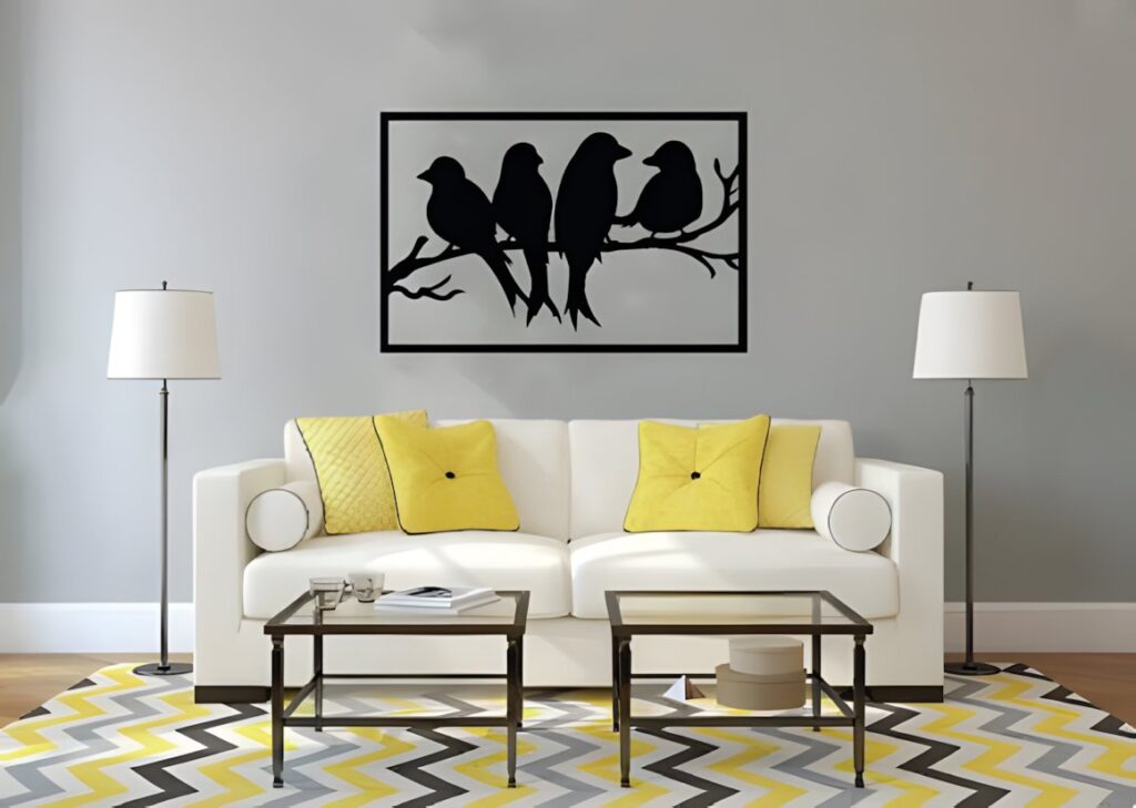 29 Laser Cut Metal Wall Art Ideas for Modern Home Decor 12 Laser cut metal wall art ideas featuring bird silhouettes on a branch above a white sofa with yellow pillows