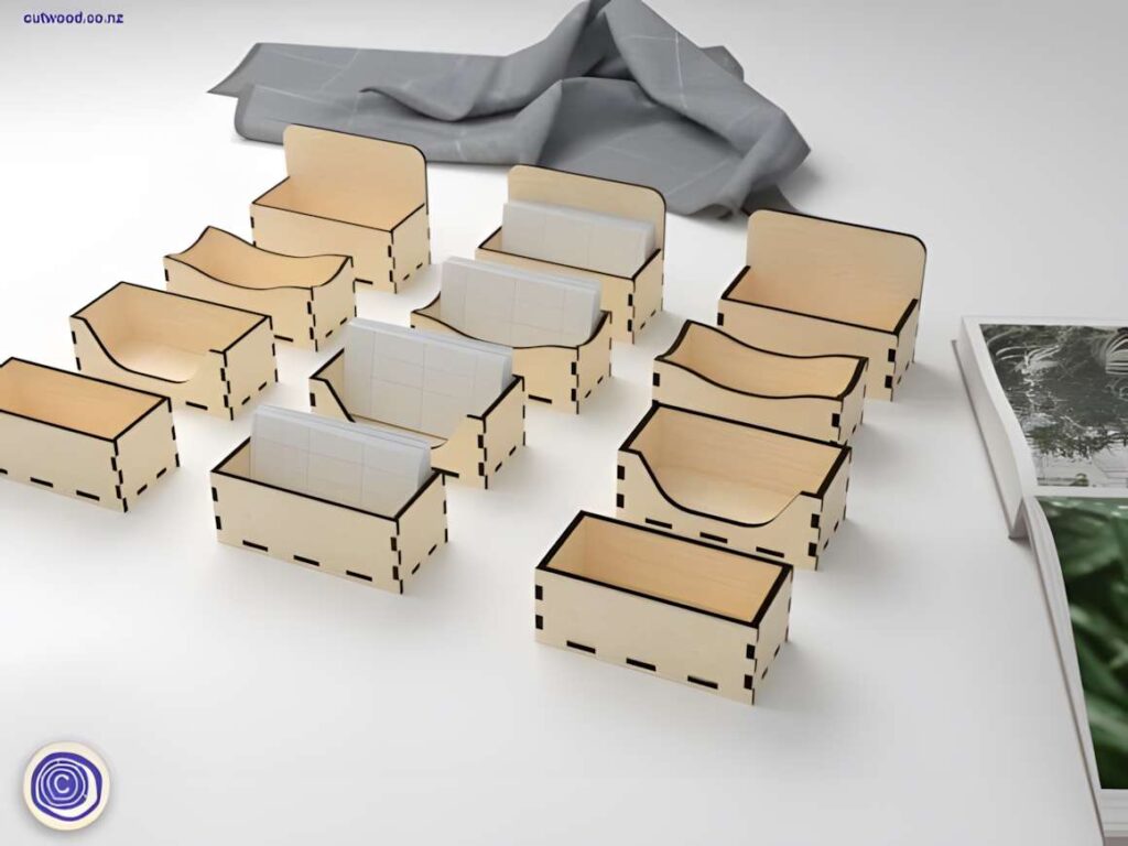 15 Laser Cut Business Card Holder SVG Files 13 laser cut business card holder designs in various styles arranged on a white surface