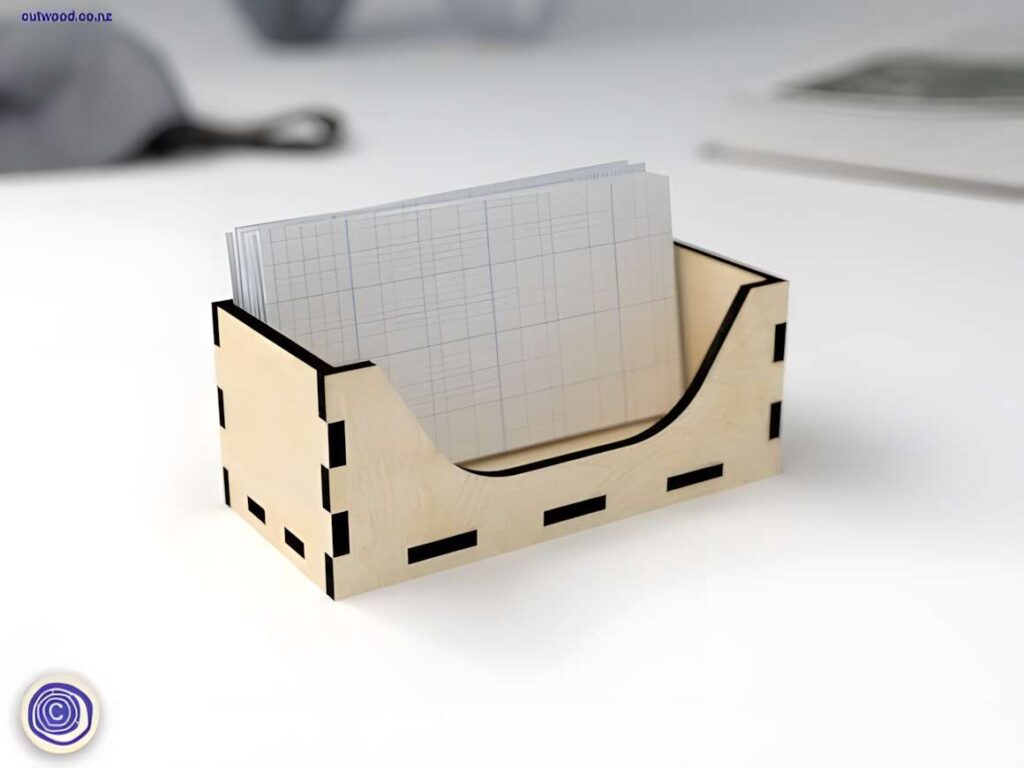 15 Laser Cut Business Card Holder SVG Files 12 laser cut business card holder made of light wood holding graph paper cards on a white surface