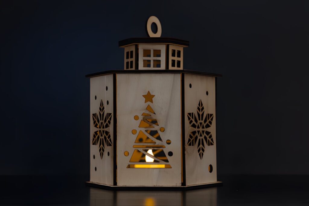 54 Christmas Laser Cut Files for Festive Laser Projects 38 Christmas Laser Cut Files lantern with star and tree cutouts illuminated from inside