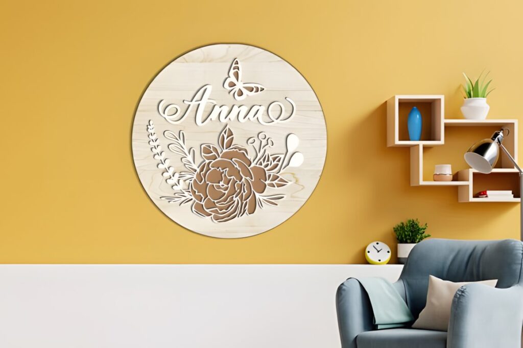 27 Laser Cut Wood Wall Art Ideas for Modern Home Decor 7 Round laser cut wood wall art with floral design and the name Anna on a yellow wall above a — laser cut wood wall art ideas