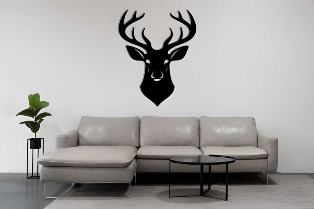50 Laser Cut Steel Wall Art Ideas for Modern Home Decor 39 Laser cut steel wall art ideas featuring a black deer head silhouette mounted above a modern gray sectional sofa in a