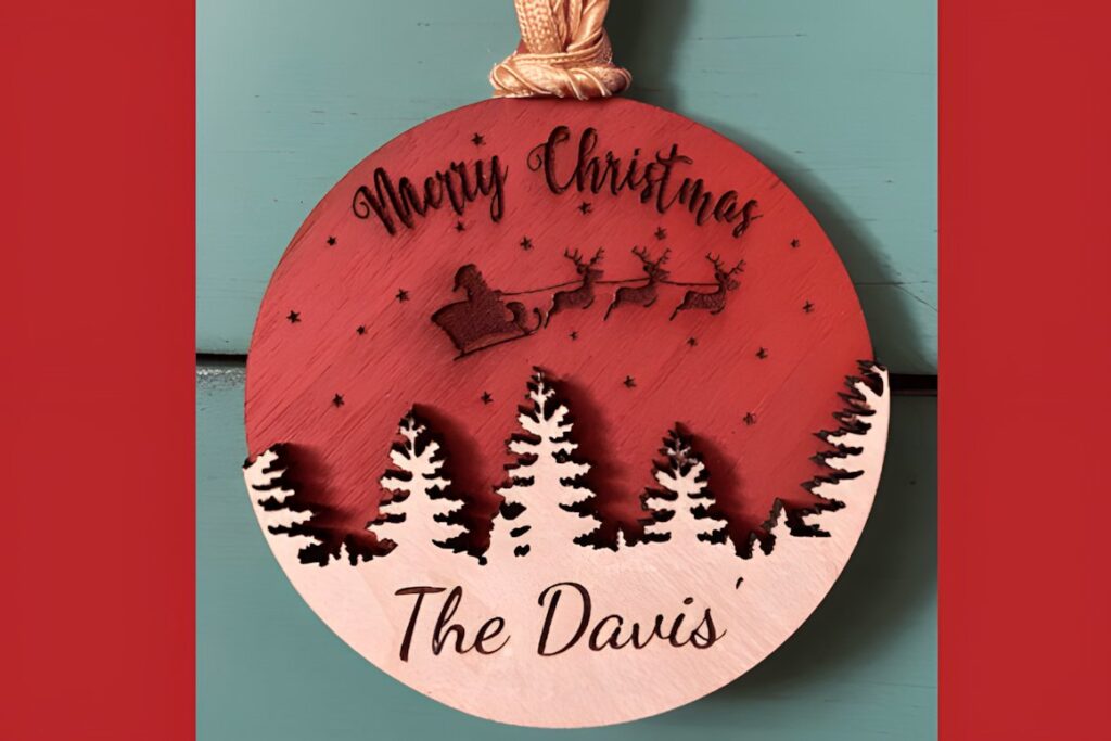 54 Christmas Laser Cut Files for Festive Laser Projects 21 Christmas Laser Cut Files wooden ornament with Santa sleigh and trees saying Merry Christmas The Davis