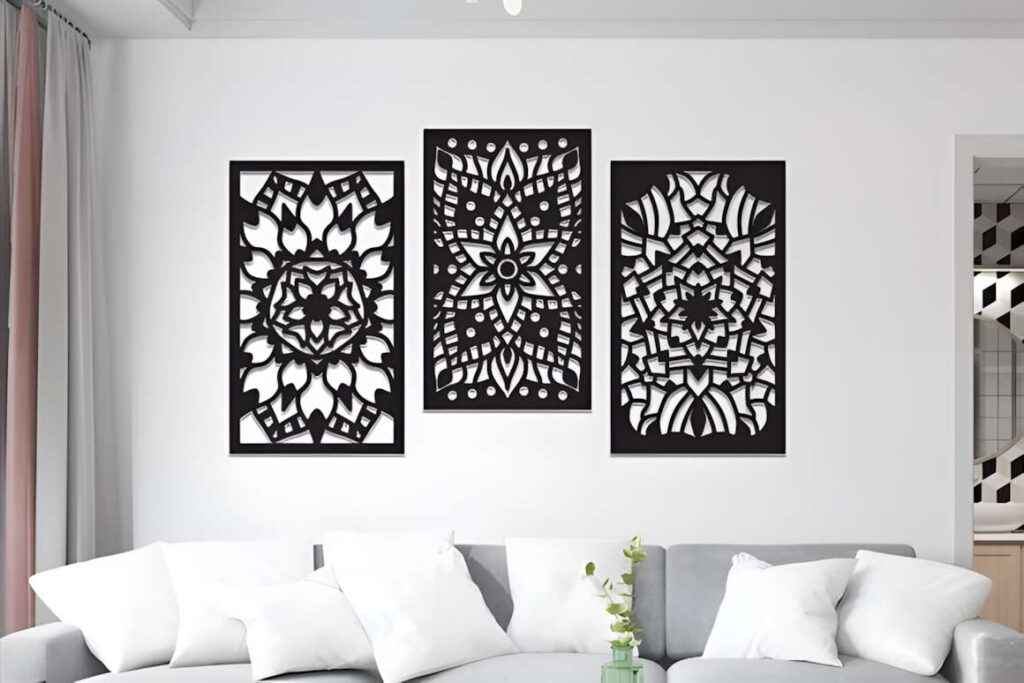 39 Outdoor Laser Cut Panels for Modern Outdoor Spaces 16 Three black outdoor laser cut panels with mandala floral and geometric designs mounted on a white wall above a gray sofa