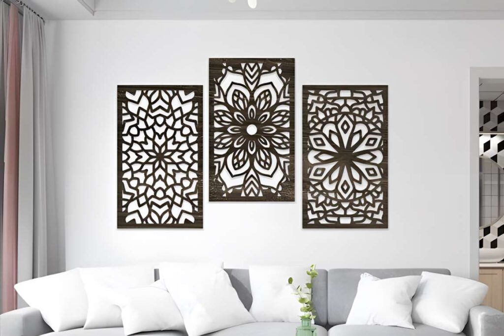 39 Outdoor Laser Cut Panels for Modern Outdoor Spaces 17 Three outdoor laser cut panels with mandala floral and geometric designs mounted on a white wall above a gray sofa