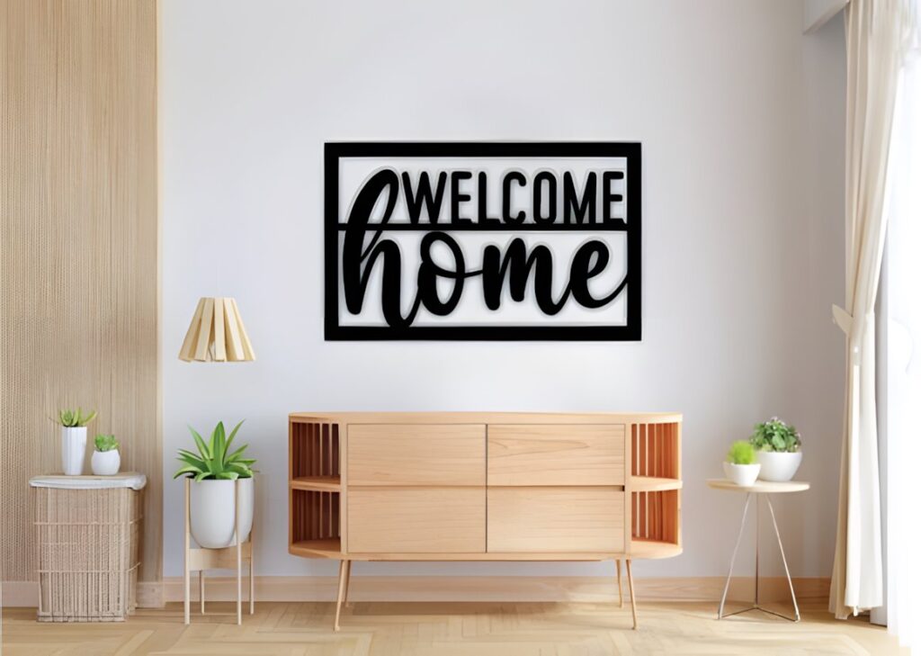 29 Laser Cut Metal Wall Art Ideas for Modern Home Decor 7 Laser cut metal wall art ideas featuring a black 'Welcome Home' sign mounted on a white wall above a wooden sideboard