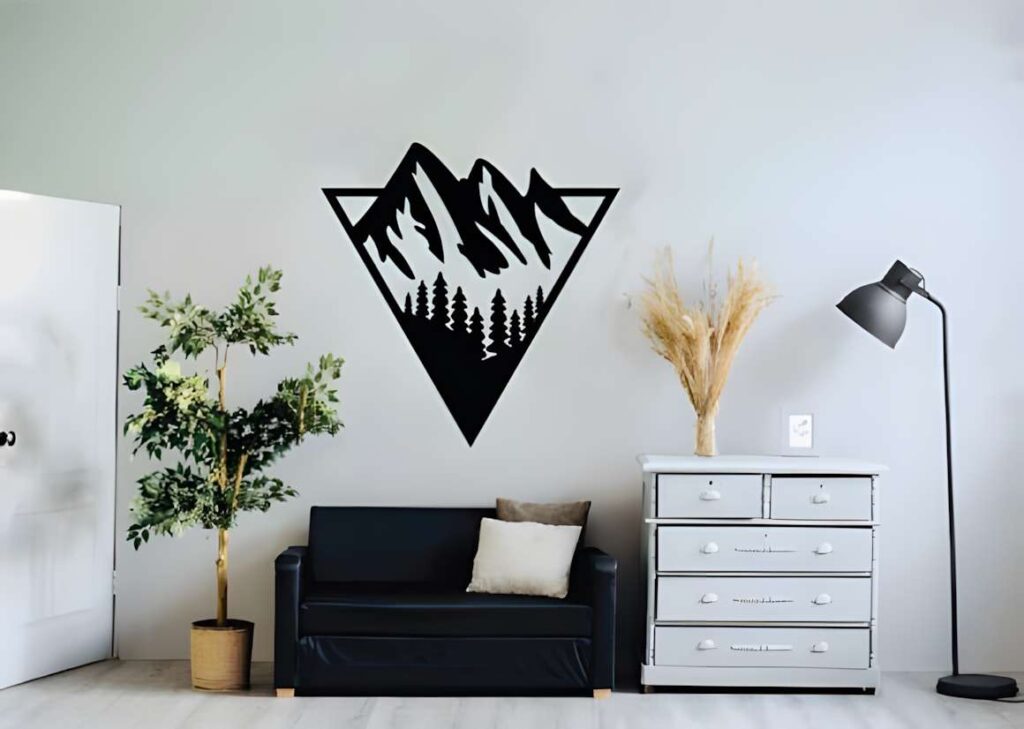50 Laser Cut Steel Wall Art Ideas for Modern Home Decor 23 laser cut steel wall art ideas showing mountain silhouette with trees in a triangular frame above black sofa